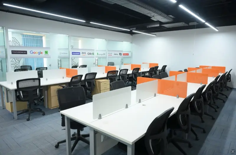 Innovation lab with partitioned workstations and technology partner logos