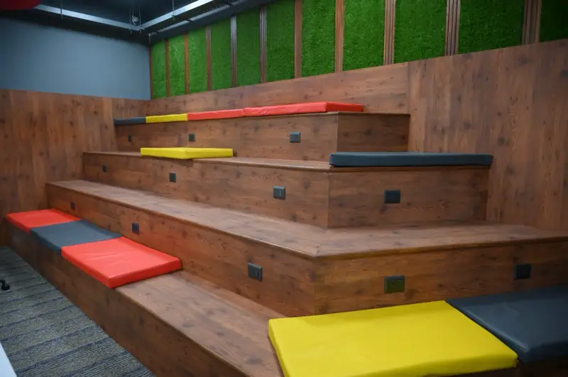Wooden tiered seating area used as an informal student collaboration space